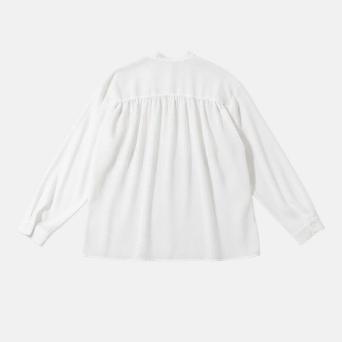 White blouse with a round neckline on a light gray background