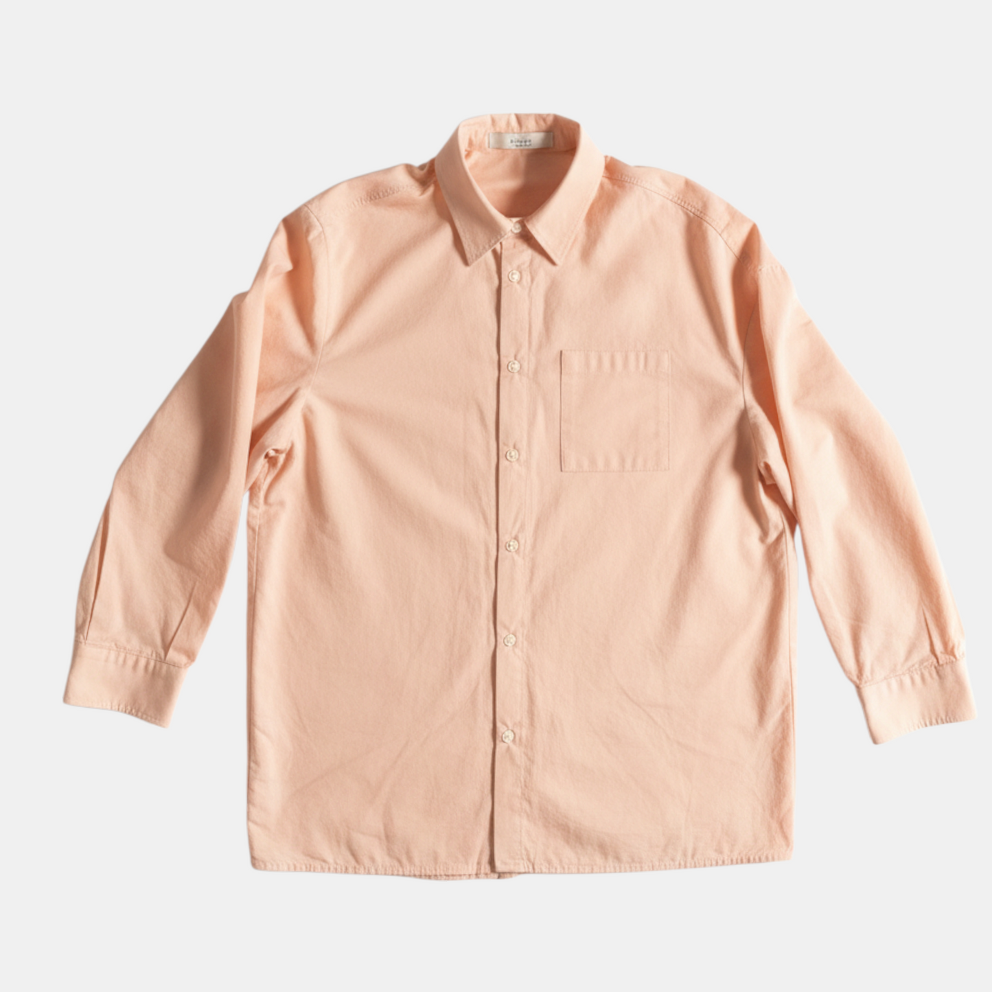 Light pink shirt on a light gray background