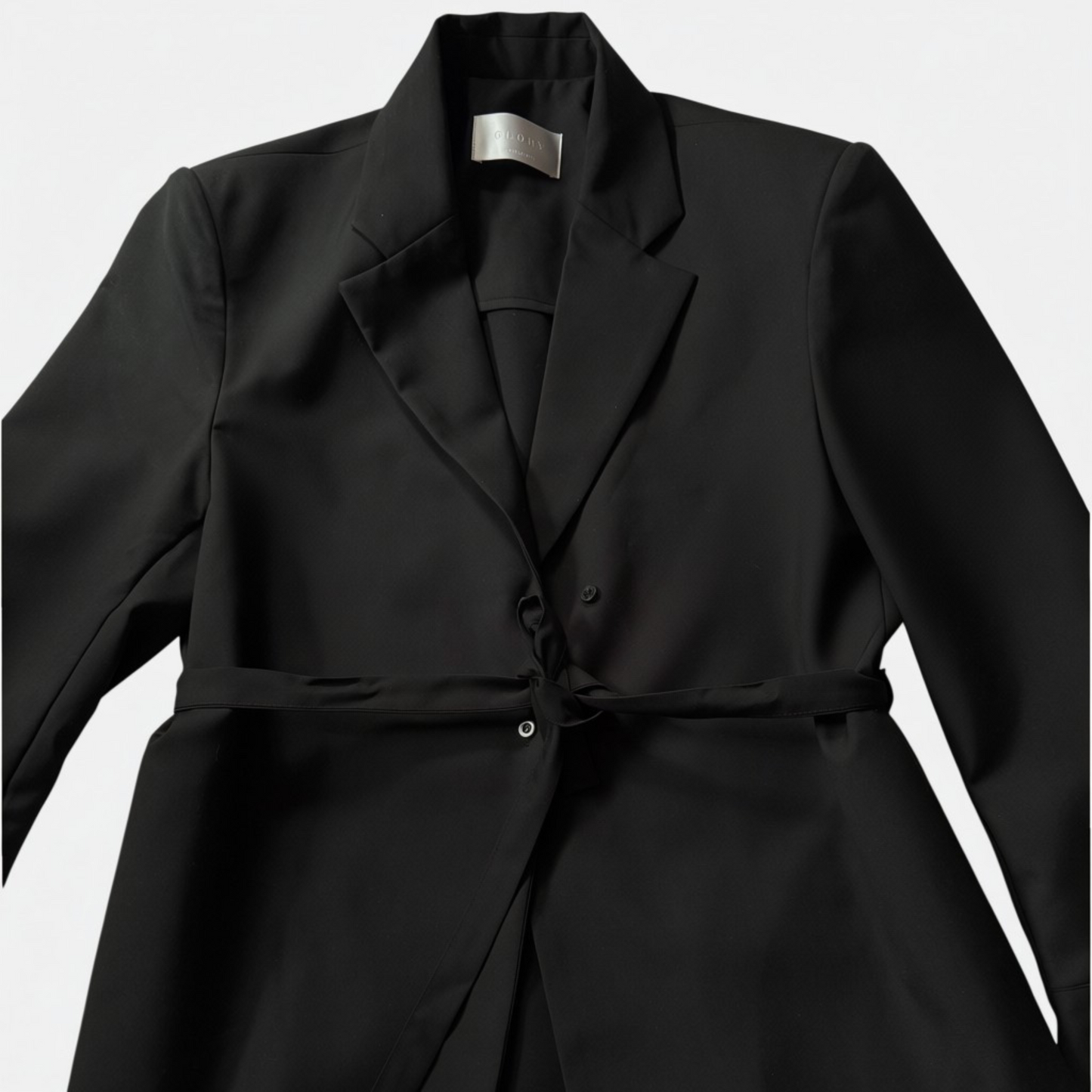Close up on a black blazer shirt with belt