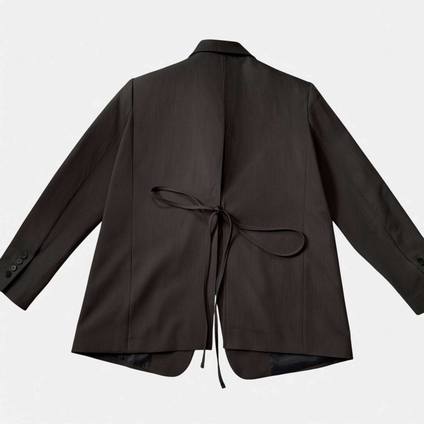 Charcoal grey jacket with a tie detail on a light gray background