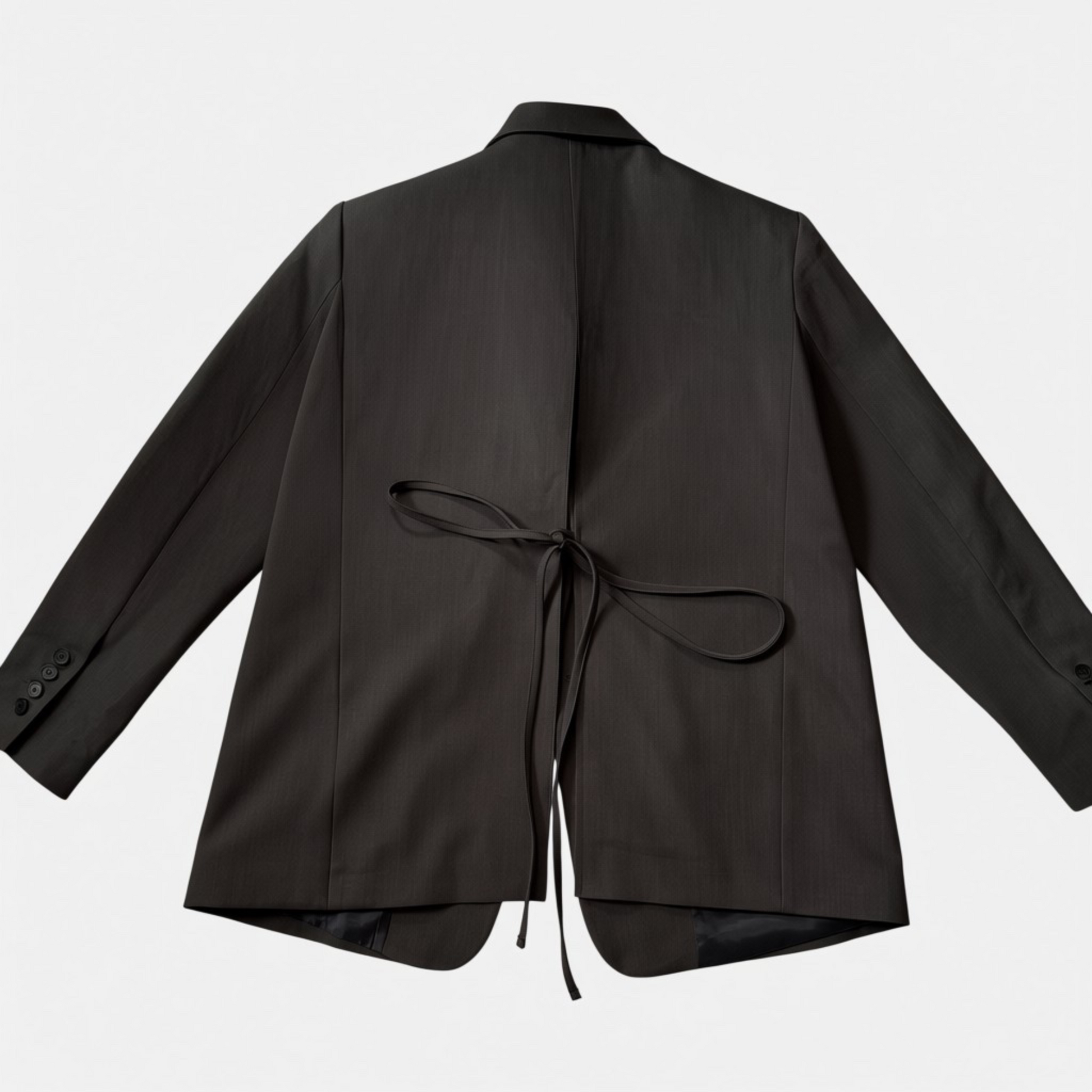 Charcoal grey jacket with a tie detail on a light gray background
