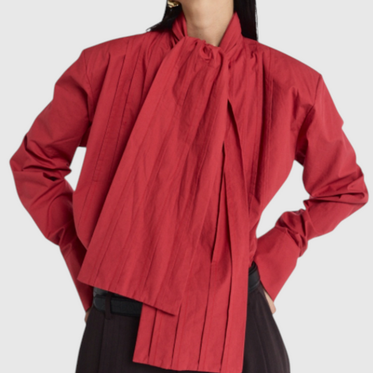 The Corporate Rebels red pintuck shirt with architectural pleating and a structured silhouette on a model.